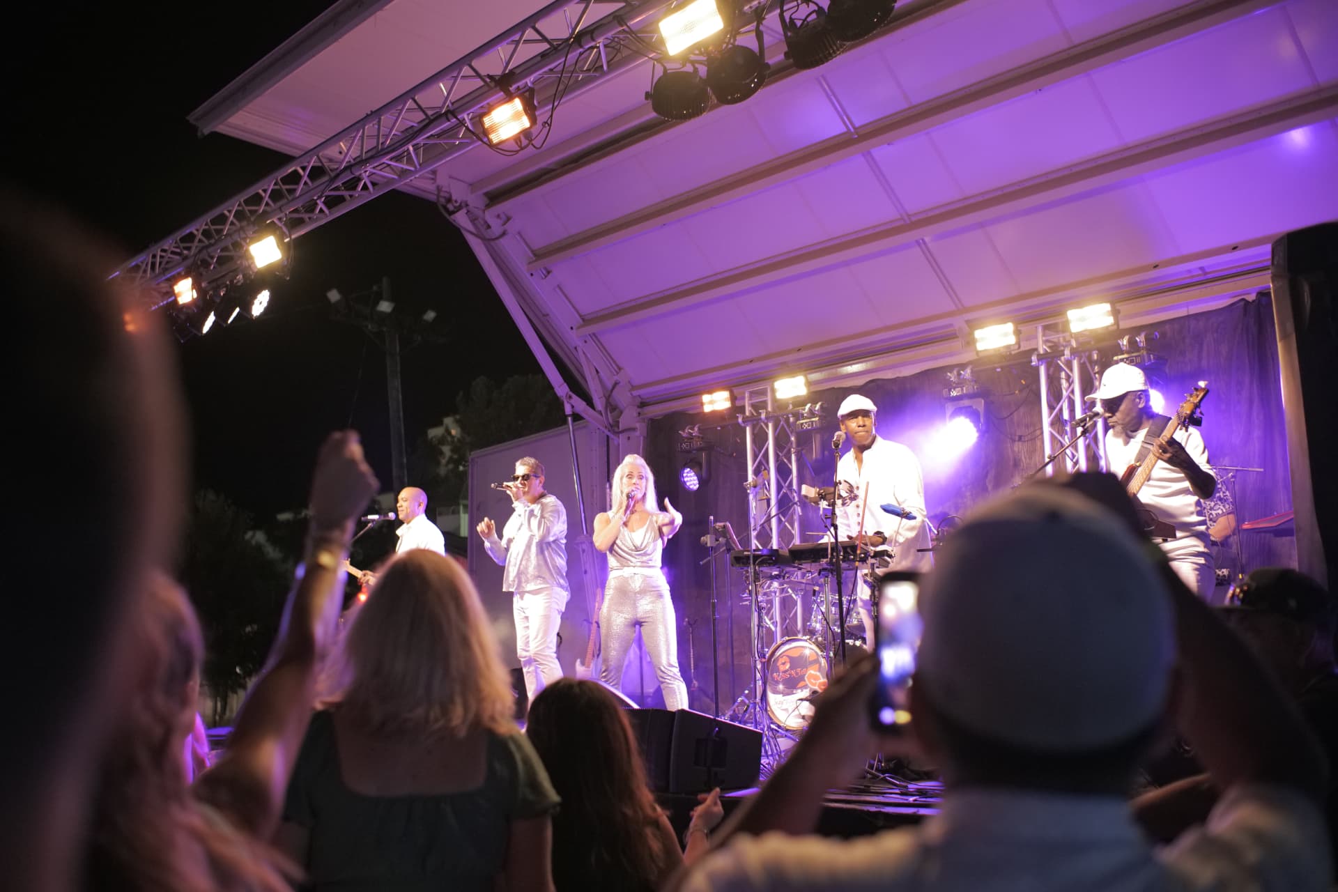 Band performing on an illuminated outdoor stage at night at the Yolo County Fair