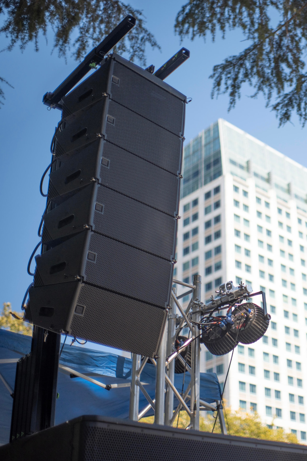 Line-array PA and lighting truss rigged above an outdoor festival stage