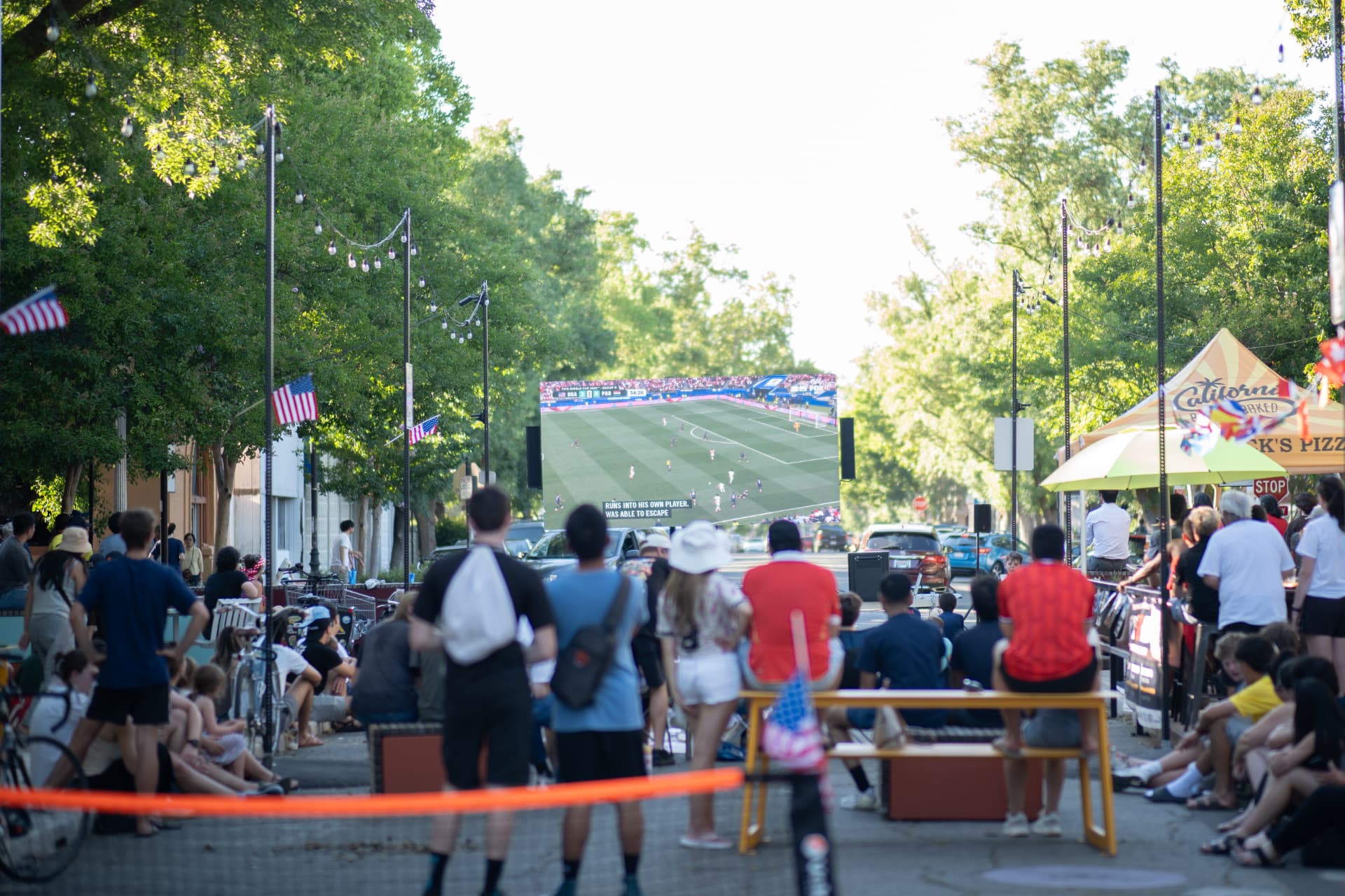 Mobile LED screen at a downtown World Cup watch party with a large crowd